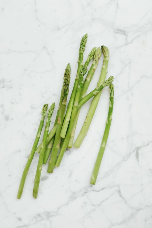 Bunch of fresh green asparagus on white marble — photo by ready made on Pexels