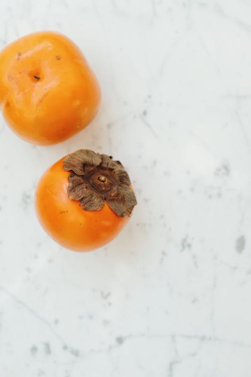 Persimmon on a White Surface