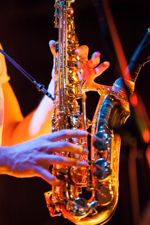 Free Close-up of hands playing a saxophone during a live jazz concert. Stock Photo