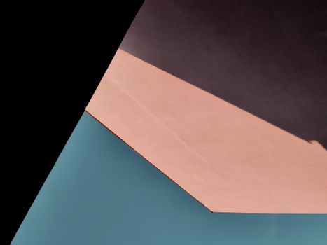 From above of contrast blue and pink roof of contemporary style house with straight lines and sun shadow on surface