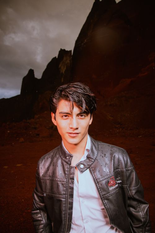 Free A stylish young man poses outdoors with a dramatic mountain backdrop in Puebla, Mexico. Stock Photo