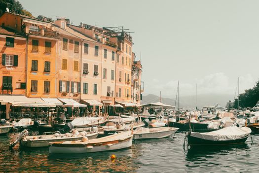 A vibrant view of Portofino's harbor filled with boats and colorful buildings under a clear sky.