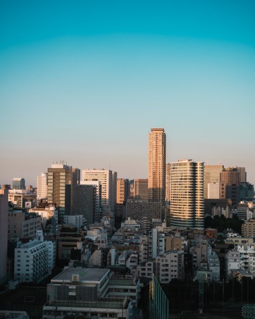 Free Captivating view of Tokyo's skyline, featuring modern skyscrapers under a clear blue sky at dusk. Stock Photo