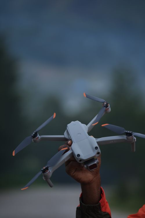 Free Close-up of a person holding a drone outdoors in Highland Papua, Indonesia, showcasing technology and exploration. Stock Photo