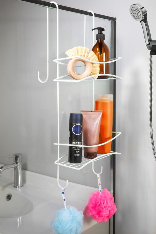 Free Compact shower organizer with toiletries and loofahs, perfect for space-saving in modern bathrooms. Stock Photo