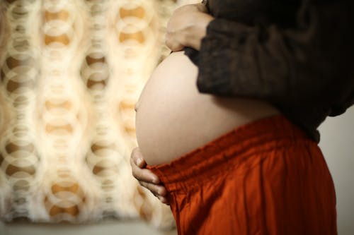 Belly of a pregnant woman legs baby. Selective focus. Selective