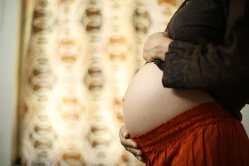 Free Pregnant Woman in Black Long Sleeve Shirt and Red Pajamas Stock Photo
