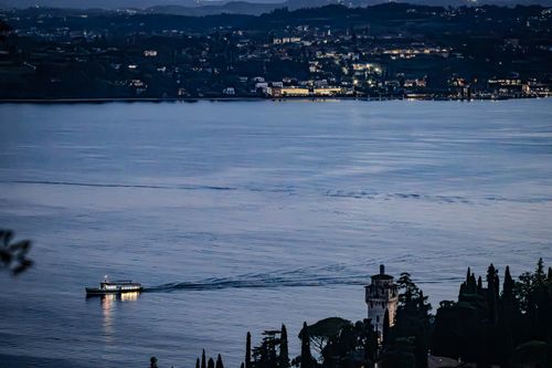 Free Evening boat ride on Lake Garda with scenic view of Gardone Riviera in Italy. Stock Photo