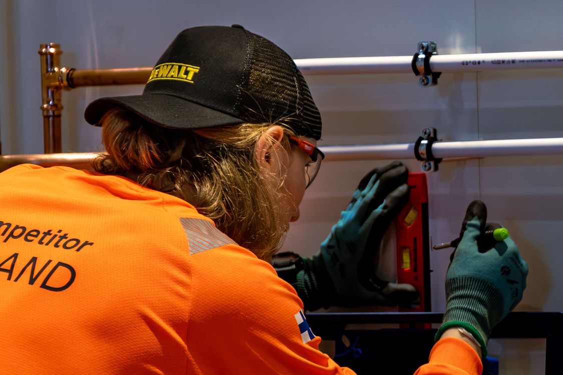 Skilled worker adjusting pipes during drain cleaning services in Bend, Oregon