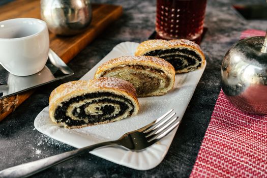 Appetizing slices of poppy seed and walnut strudel on a plate, perfect for dessert lovers.