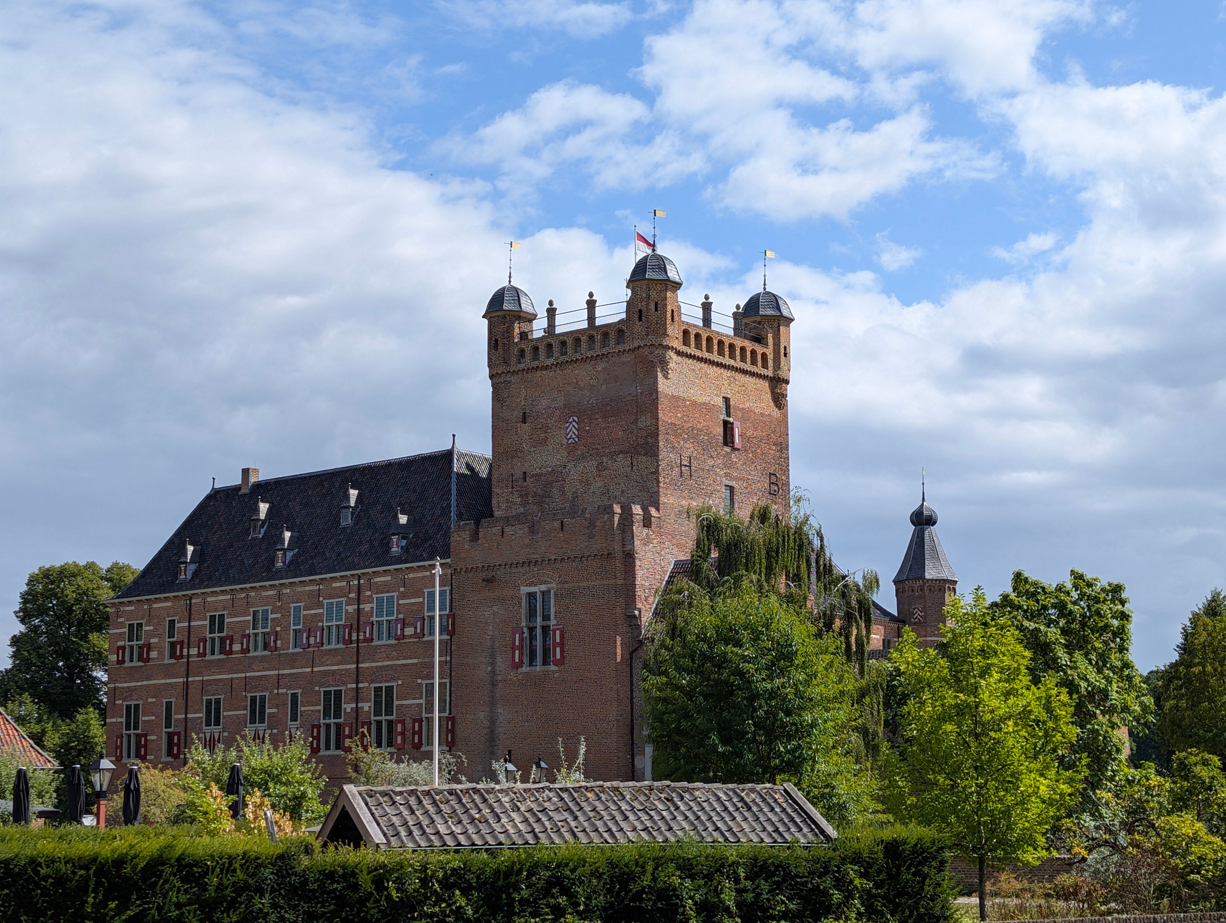 Charming medieval castle with turrets and lush greenery in the Netherlands.