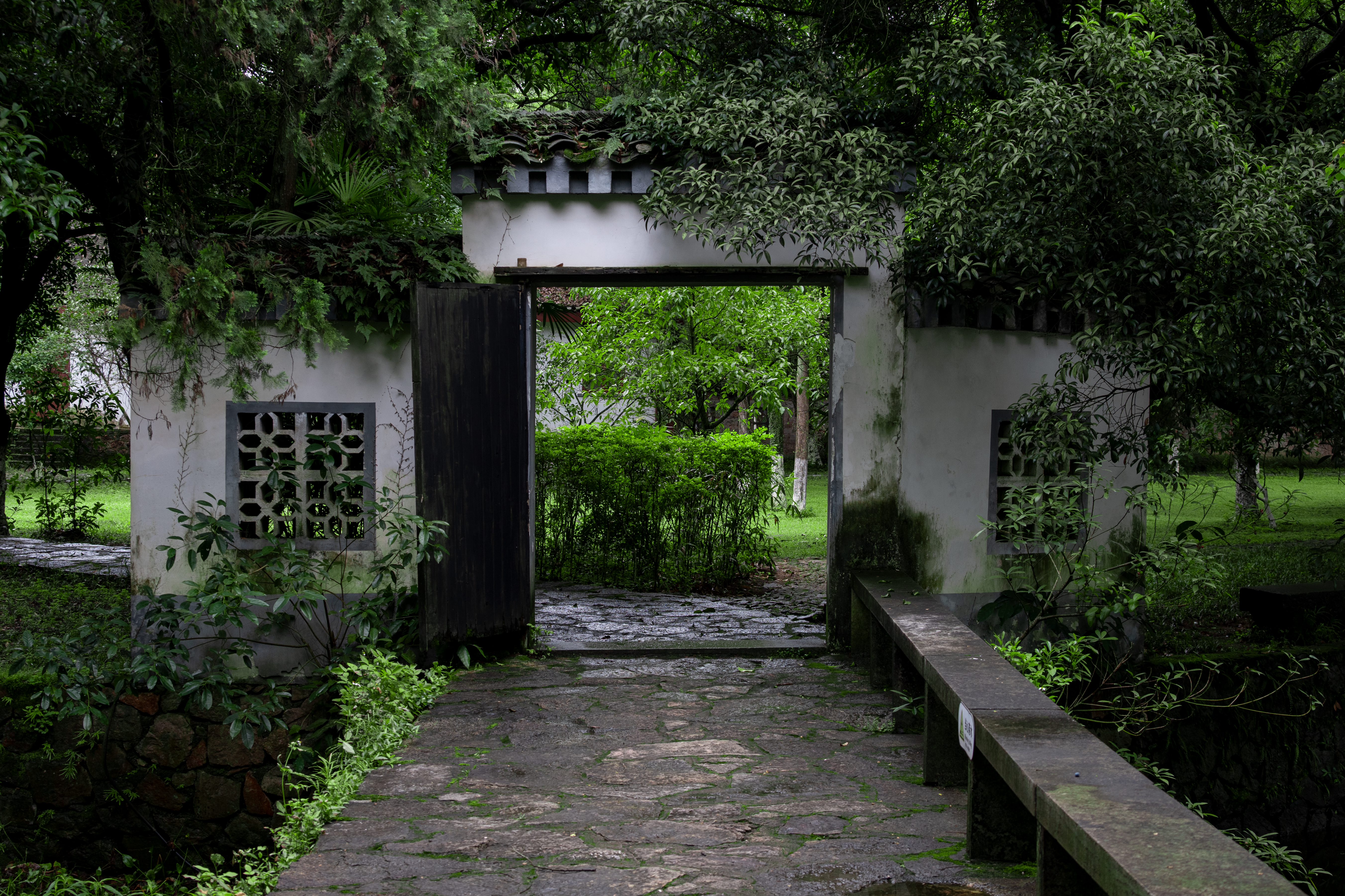 Tranquil Chinese Garden Gate In Lush Greenery · Free Stock Photo