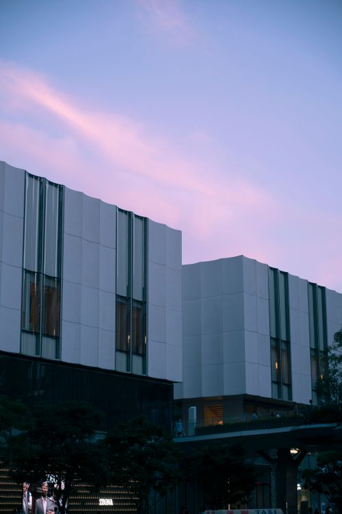 Free Contemporary buildings illuminated by soft sunset light, showcasing modern architecture. Stock Photo