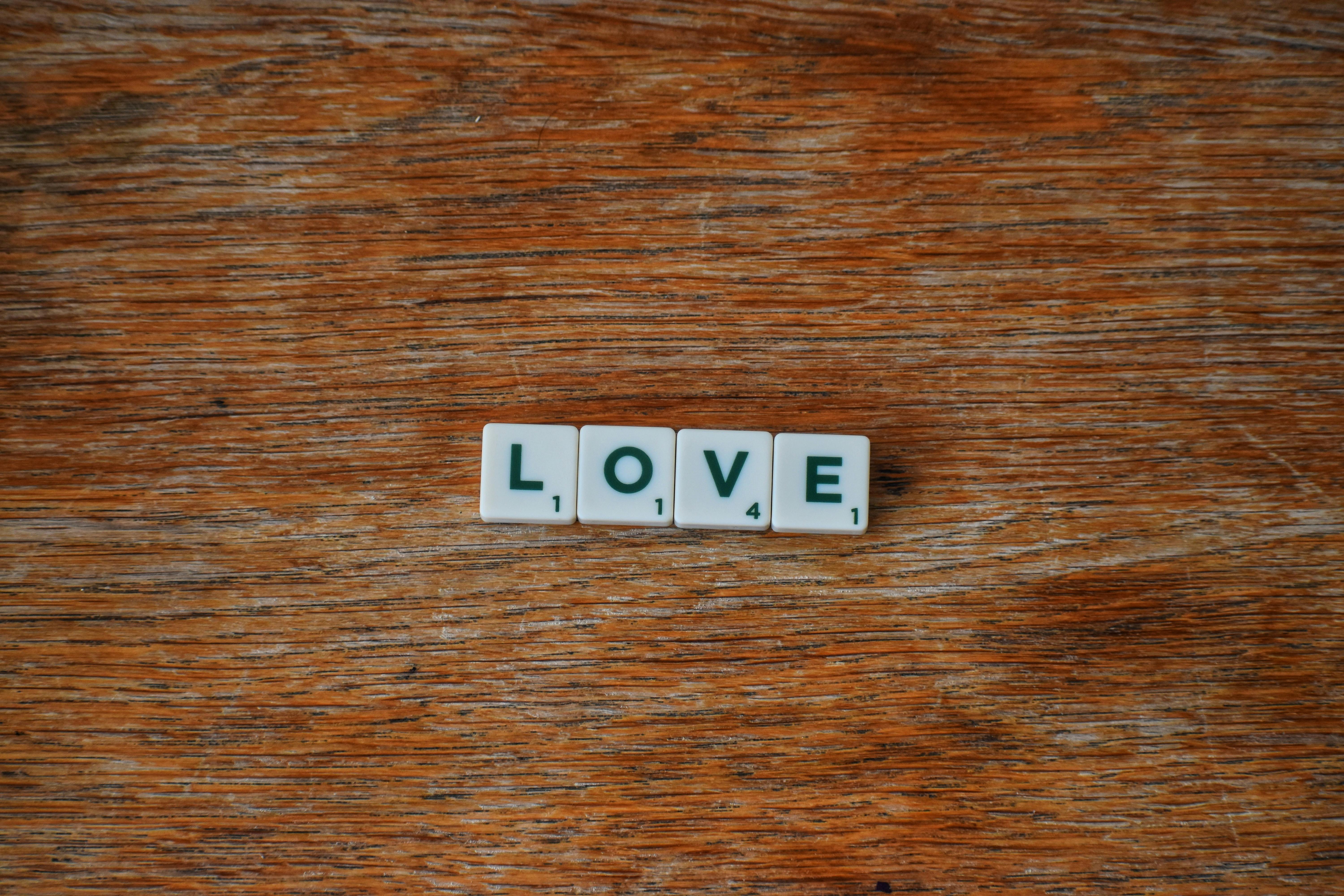 white and black love on brown wooden table