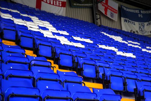 Free Vibrant blue and white stadium seats arranged in rows with team banners displayed above. Stock Photo