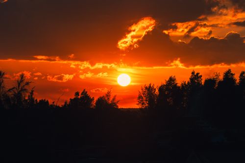 Free Witness the breathtaking sunset over Cửa Tùng, Vietnam with vibrant skies and silhouetted trees. Stock Photo