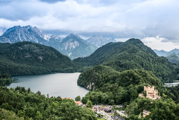 Green Mountains Near River Under Blue Sky