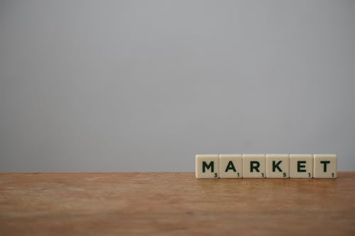 White and Black Market Word on Wooden Table