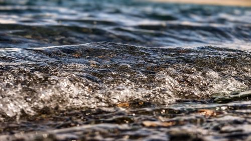 Free Captivating close-up of rippling water and bubbles on the surface, showcasing nature's serene beauty. Stock Photo
