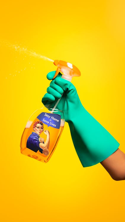 Person Holding Yellow and White Labeled Bottle