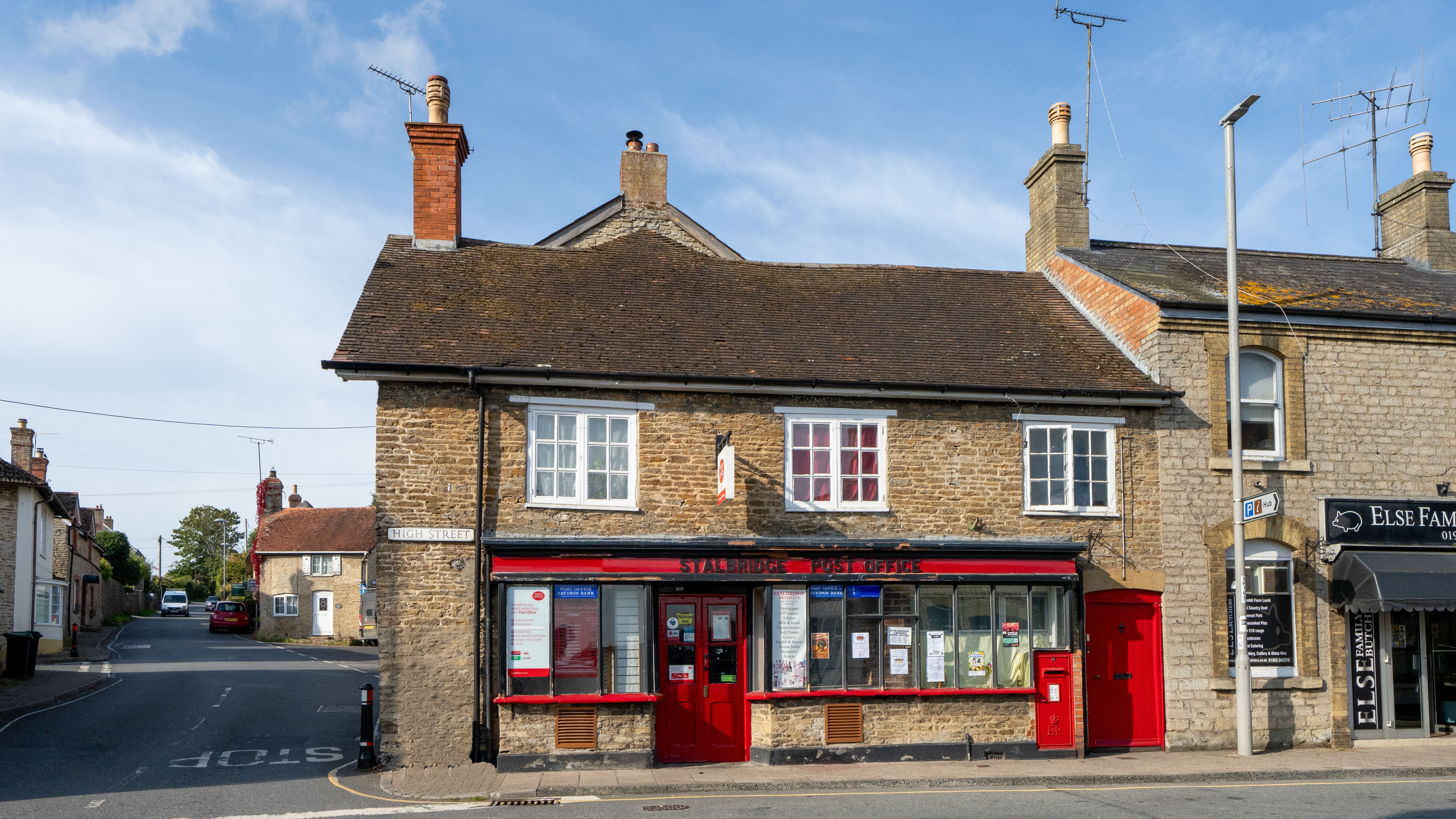 Historic Stalbridge post office with classic architecture under a clear sky.