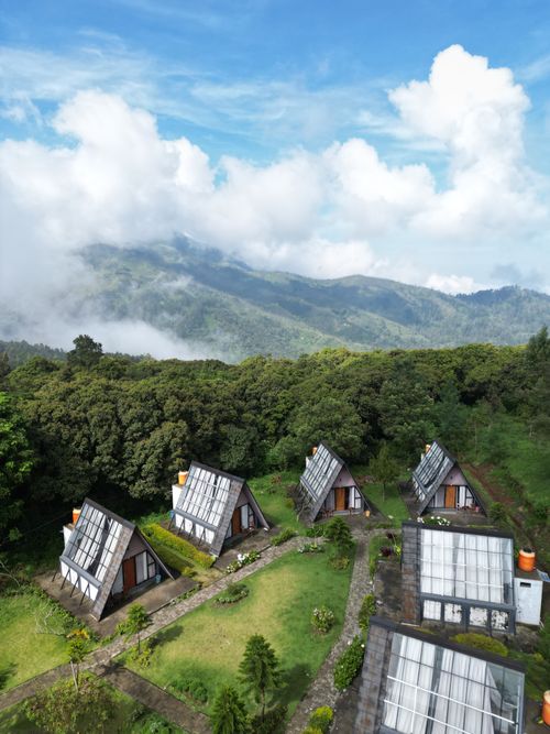 Free Beautiful A-frame cabins nestled in lush mountains with a breathtaking view. Stock Photo