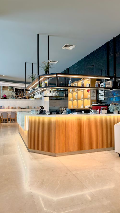 Free Bright and elegant coffee shop interior with stylish bar counter and seating area. Stock Photo