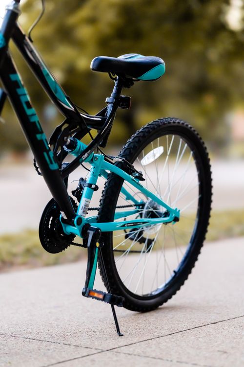 Free Detailed view of a stylish bicycle parked on a sunny sidewalk. Stock Photo