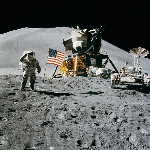 Astronaut Standing Beside American Flag on the Moon