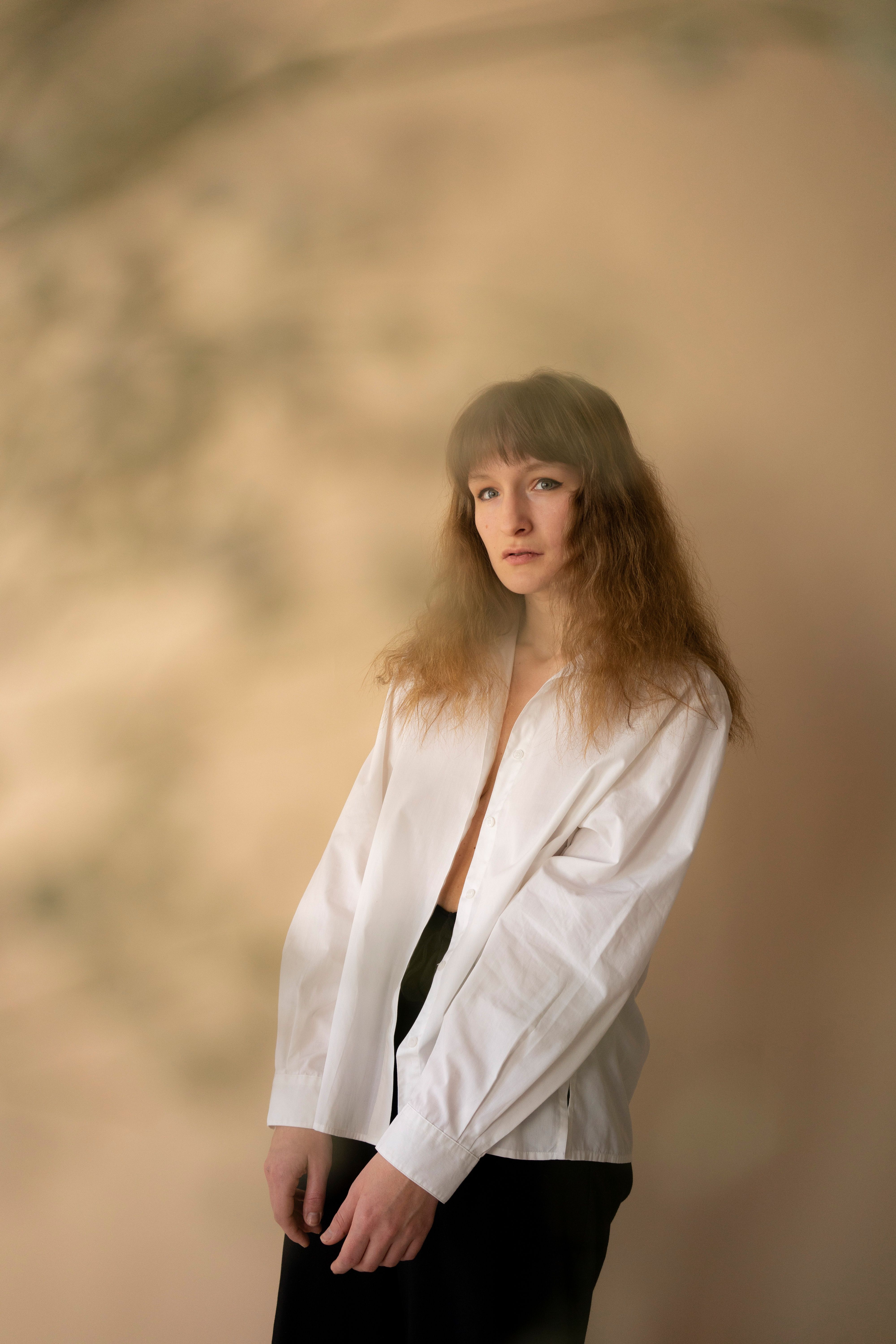Model wearing a relaxed cotton shirt near a neutral wall