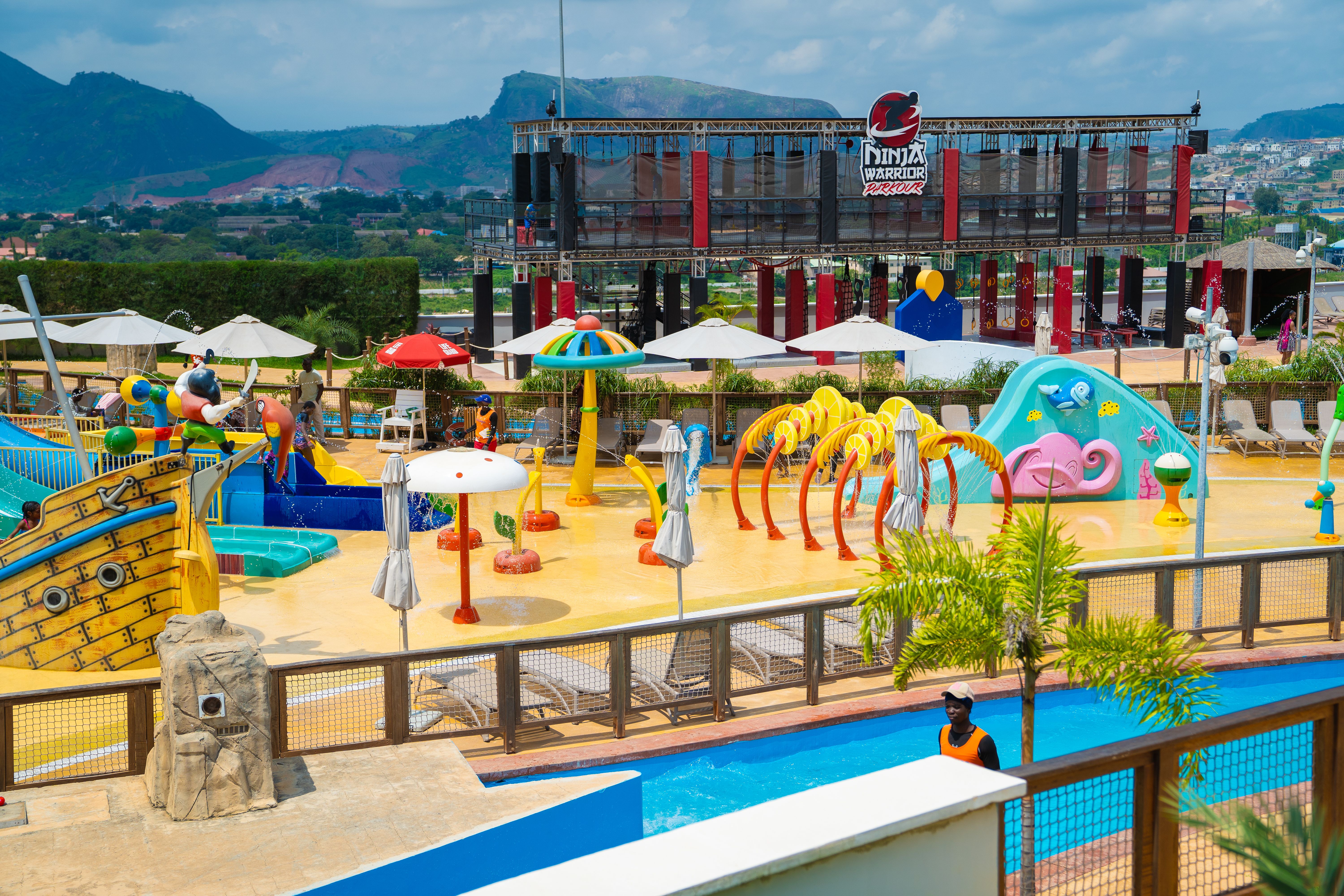 Vibrant outdoor water park featuring colorful slides and splash zones on a sunny day.