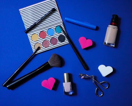 Free Makeup Products on Blue Surface Stock Photo