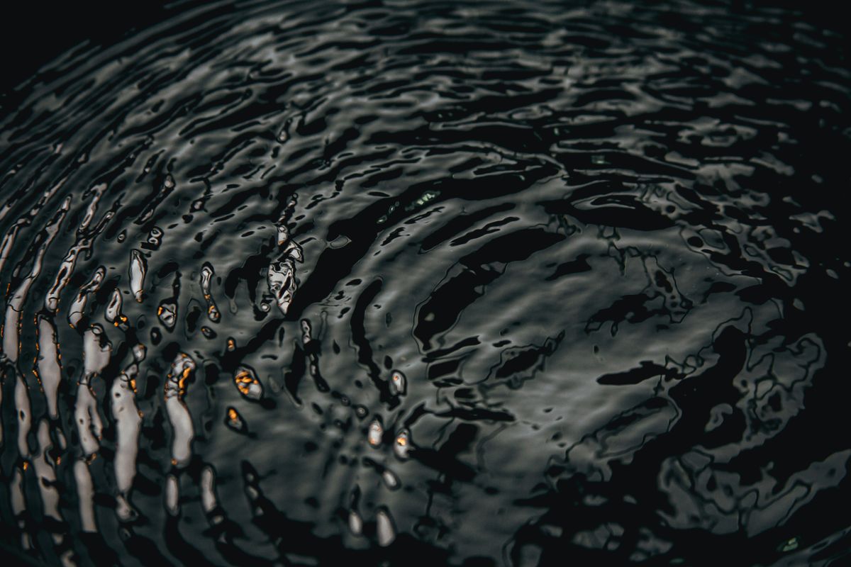 Dark rippling water surface catching low light — Ave Calvar Martinez on Pexels