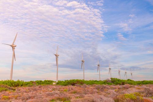 Free A line of wind turbines against a beautiful sky in a natural landscape, showcasing renewable energy. Stock Photo