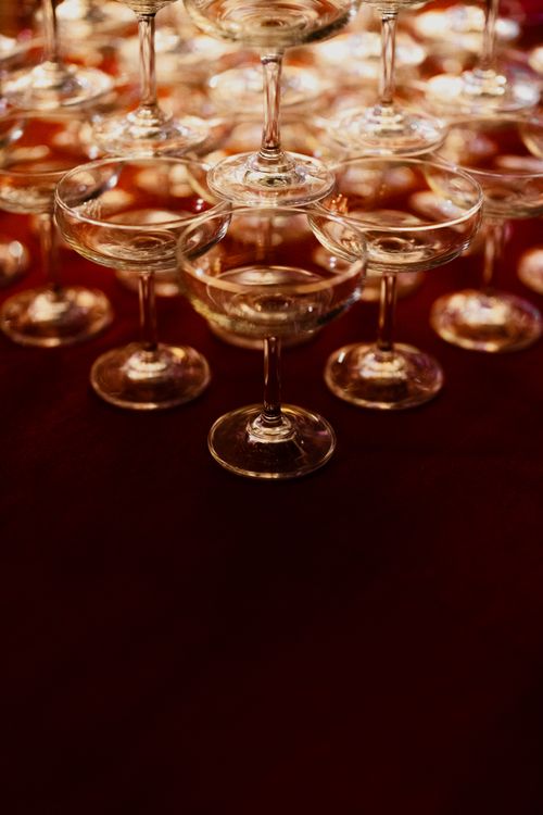 Free Artistic arrangement of champagne glasses forming a pyramid at an elegant event. Stock Photo