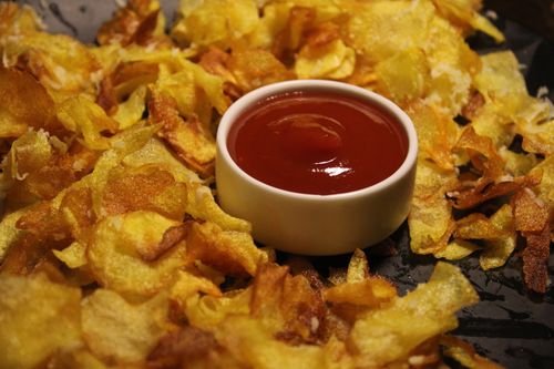 Free Golden crispy chips served with a bowl of tomato ketchup, perfect snack delight. Stock Photo