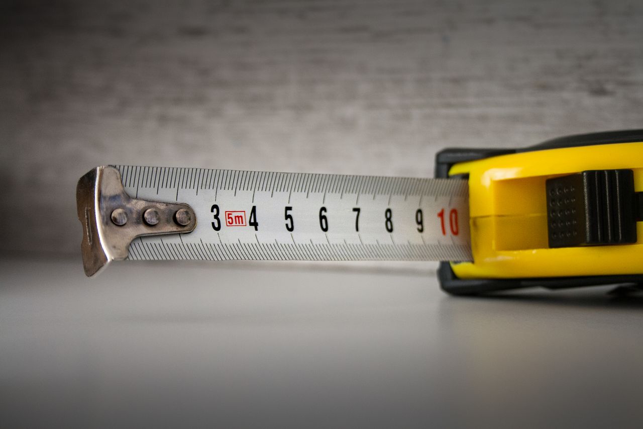 Close-up of a yellow tape measure extended