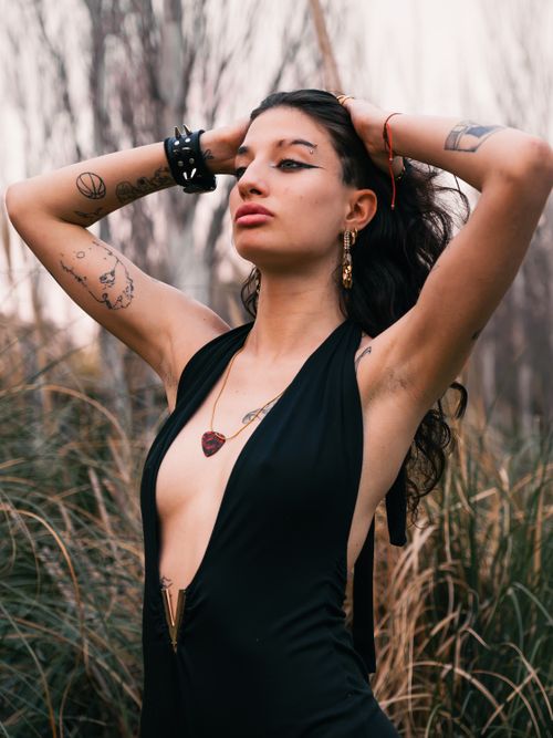 Free Elegant portrait of a tattooed model posing confidently outdoors in Buenos Aires. Stock Photo