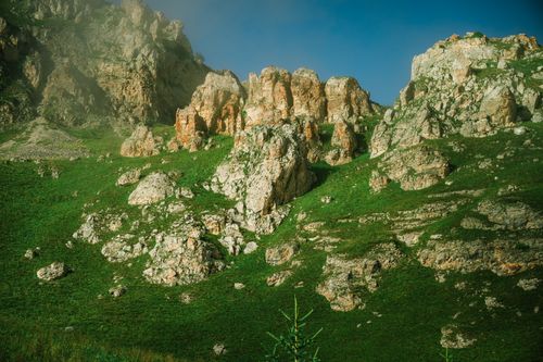 Free A stunning view of rocky formations amidst green hills in Chechnya, Russia. Stock Photo