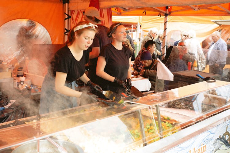 Women In Black Shirt Selling Food In Food Stall