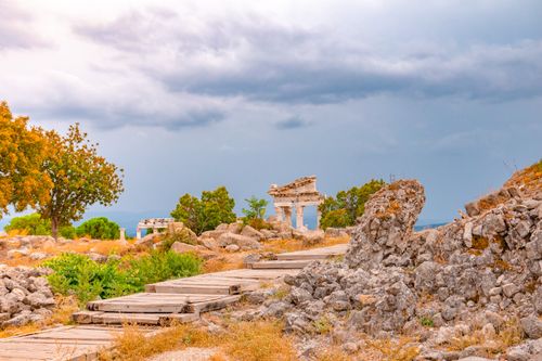 Free Serene view of ancient ruins and stone path under an overcast sky. Stock Photo