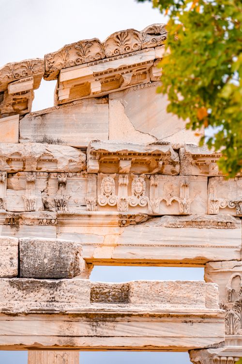 Free Detailed view of an ancient Greek temple ruin showcasing ornate carvings and architectural elements. Stock Photo
