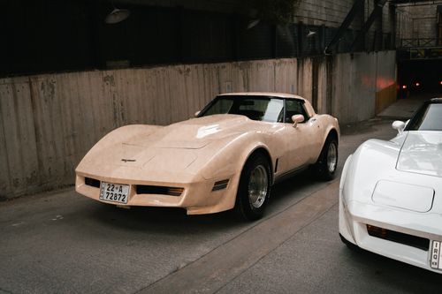 Free Vintage cars parked in a concrete urban tunnel in Erbil, Iraq, showcasing retro style. Stock Photo