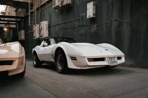 Free A vintage white sports car parked in an urban alley in Erbil, Iraq. Stock Photo