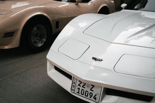 Free Close-up of a classic white sports car parked in Erbil, showcasing its sleek design and local license plate. Stock Photo