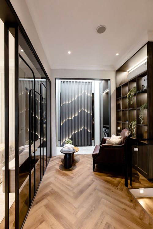 Free A stylish modern interior space with herringbone wooden flooring and decorative lighting. Stock Photo