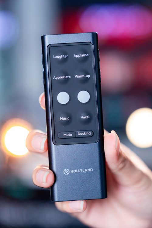 Free A close-up view of a remote control for audio effects handheld, featuring labeled buttons for laughter and applause. Stock Photo