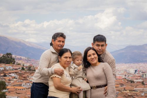 Free A family enjoying a scenic view over a city with a mountainous backdrop. Perfect for lifestyle and travel themes. Stock Photo
