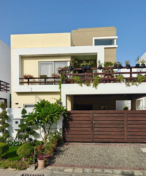 Free Spacious modern house with a garden under a clear sky. Ideal for real estate. Stock Photo