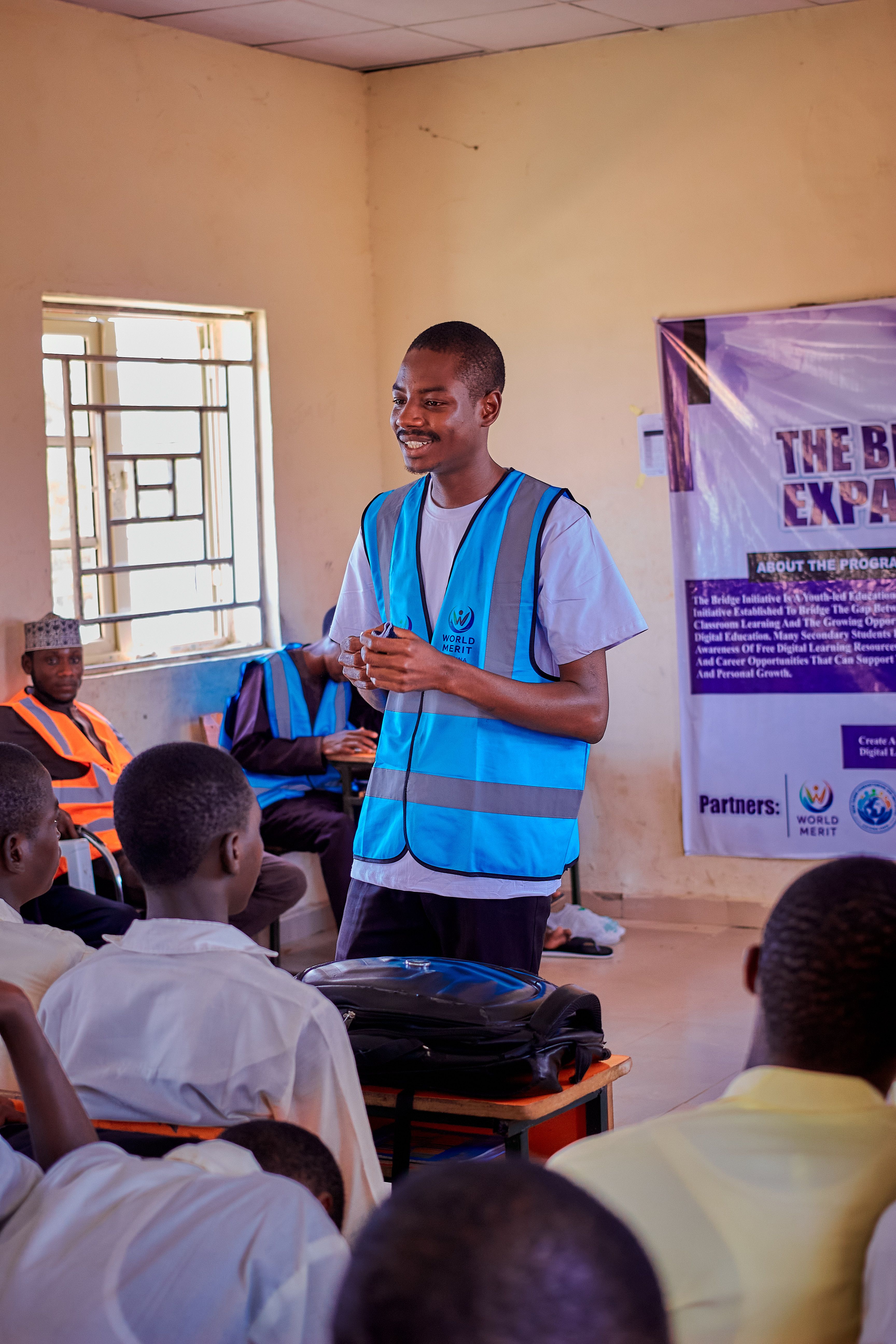 A youth leader guides students in an engaging educational session in Dutsin-Ma, Nigeria.